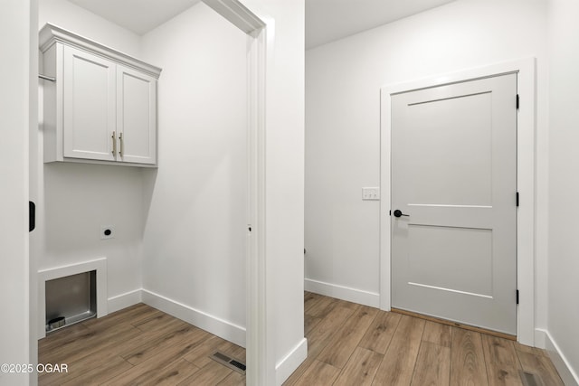 4402 Par Ln, Joplin, MO 64804 - laundry room featuring cabinet space, hookup for an electric dryer, and light wood-type flooring