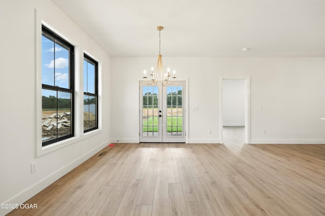 4402 Par Ln, Joplin, MO 64804 - unfurnished room with a chandelier, light wood finished floors, and french doors