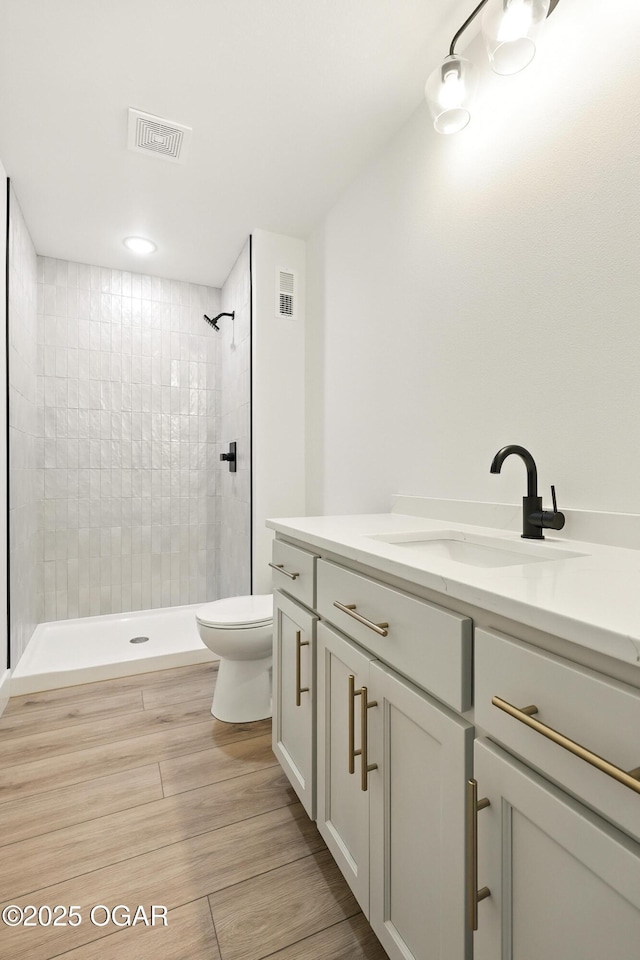 4402 Par Ln, Joplin, MO 64804 - bathroom with vanity, tiled shower, and wood finished floors
