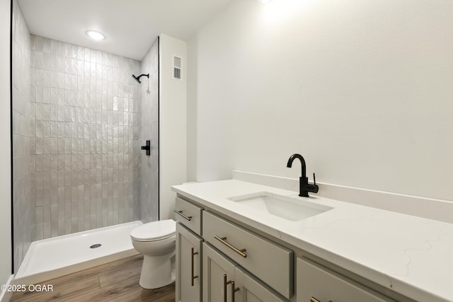4402 Par Ln, Joplin, MO 64804 - bathroom with vanity, a tile shower, and wood finished floors