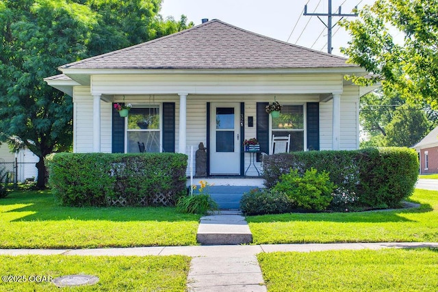 321 S Mcconnell, Joplin, MO 64801 - view of front of home with a shingled roof, covered porch, and a front yard