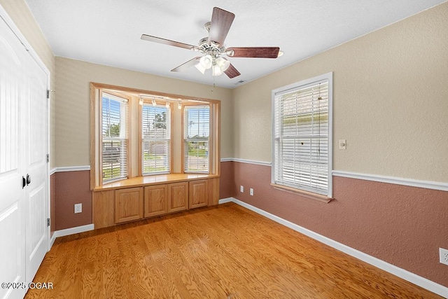 2329 S Willard Ave, Joplin, MO 64804 - empty room with light wood-style floors, a ceiling fan, and a textured wall