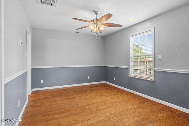 2329 S Willard Ave, Joplin, MO 64804 - unfurnished room with ceiling fan, wood finished floors, a textured ceiling, and a textured wall