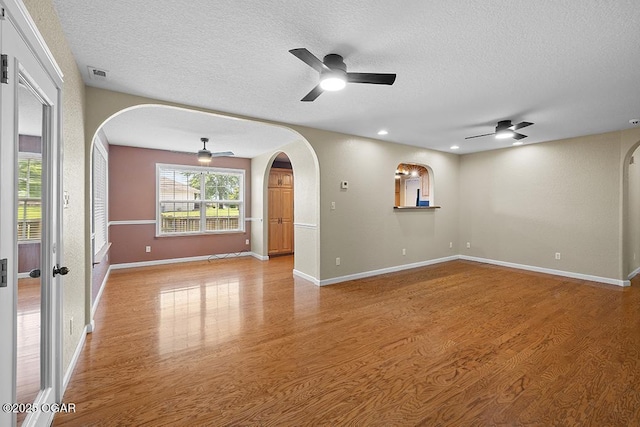 2329 S Willard Ave, Joplin, MO 64804 - empty room featuring arched walkways, ceiling fan, a textured ceiling, light wood-style flooring, and recessed lighting