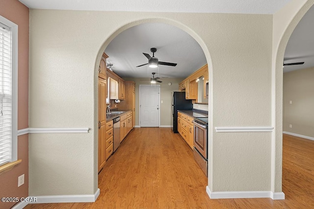 2329 S Willard Ave, Joplin, MO 64804 - kitchen with stainless steel appliances, ceiling fan, dark countertops, and arched walkways