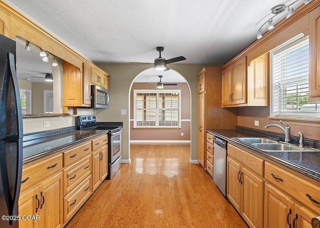 2329 S Willard Ave, Joplin, MO 64804 - kitchen with appliances with stainless steel finishes, ceiling fan, dark countertops, light wood-type flooring, and a textured ceiling