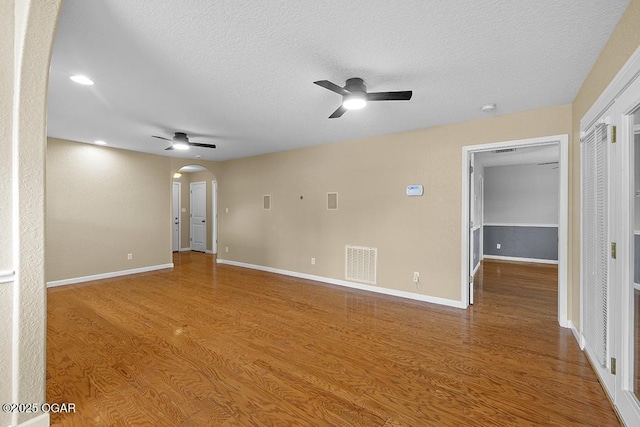 2329 S Willard Ave, Joplin, MO 64804 - unfurnished room with a ceiling fan, arched walkways, a textured ceiling, wood finished floors, and recessed lighting