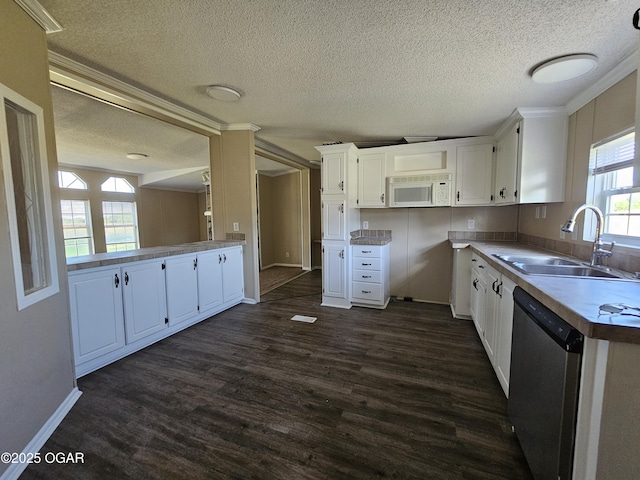 205 College St, Stark City, MO 64866 - kitchen featuring stainless steel dishwasher, white microwave, a textured ceiling, dark wood-style flooring, and white cabinets
