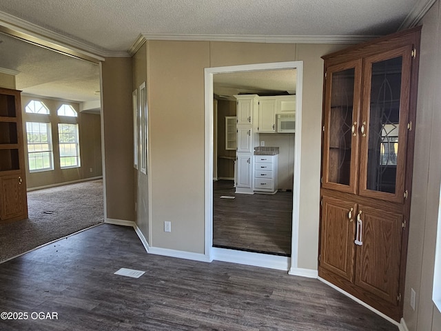 205 College St, Stark City, MO 64866 - foyer with a textured ceiling, dark wood finished floors, and crown molding