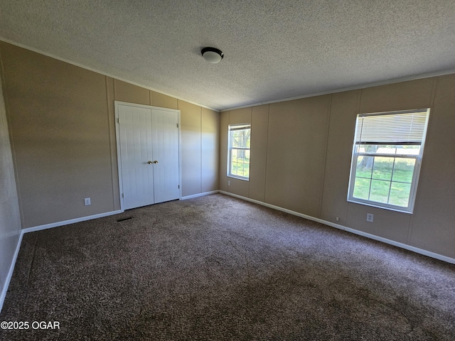 205 College St, Stark City, MO 64866 - spare room with a textured ceiling, vaulted ceiling, and carpet floors