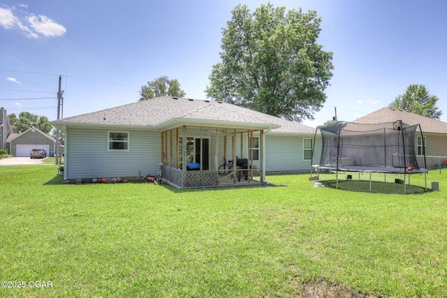 1717 Logan Drive `, Webb City, MO 64870 - back of property with a trampoline, a yard, roof with shingles, and a patio