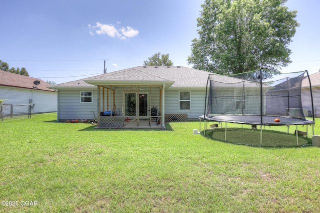 1717 Logan Drive `, Webb City, MO 64870 - back of property featuring a trampoline, a patio area, a yard, and roof with shingles