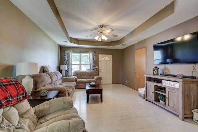 1717 Logan Drive `, Webb City, MO 64870 - living room with a ceiling fan, a raised ceiling, and light wood finished floors