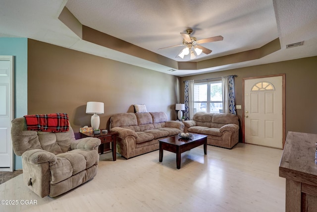 1717 Logan Drive `, Webb City, MO 64870 - living room with ceiling fan, light wood-style flooring, a tray ceiling, and a textured ceiling