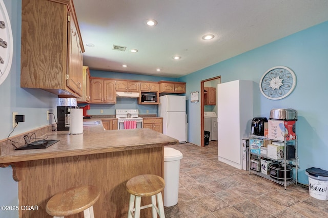 1717 Logan Drive `, Webb City, MO 64870 - kitchen featuring white appliances, under cabinet range hood, a peninsula, recessed lighting, and a kitchen breakfast bar