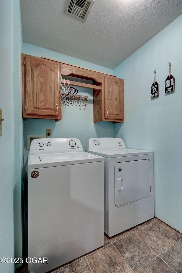 1717 Logan Drive `, Webb City, MO 64870 - laundry area featuring cabinet space, washer and clothes dryer, stone finish flooring, and a textured ceiling