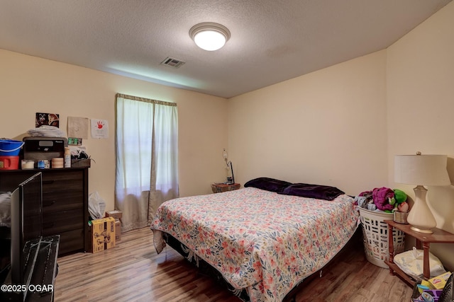 1717 Logan Drive `, Webb City, MO 64870 - bedroom featuring wood finished floors and a textured ceiling
