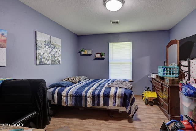 1717 Logan Drive `, Webb City, MO 64870 - bedroom featuring wood finished floors and a textured ceiling