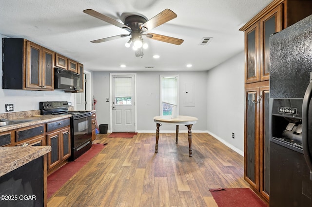624 N Devon St, Webb City, MO 64870 - kitchen with black appliances, dark wood-type flooring, glass insert cabinets, a ceiling fan, and recessed lighting