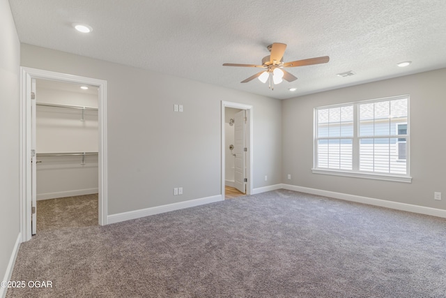 1220 Sheila Ann Dr, Carthage, MO 64836 - unfurnished bedroom featuring carpet flooring, a walk in closet, a textured ceiling, recessed lighting, and a closet