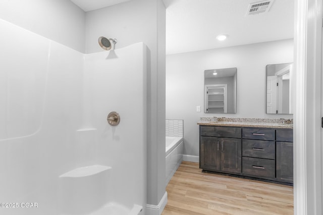 1224 Sheila Ann Dr, Carthage, MO 64836 - full bath featuring double vanity, a bath, wood finished floors, and a shower