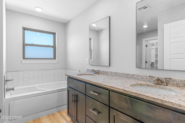 1224 Sheila Ann Dr, Carthage, MO 64836 - full bath featuring double vanity, a garden tub, and wood finished floors