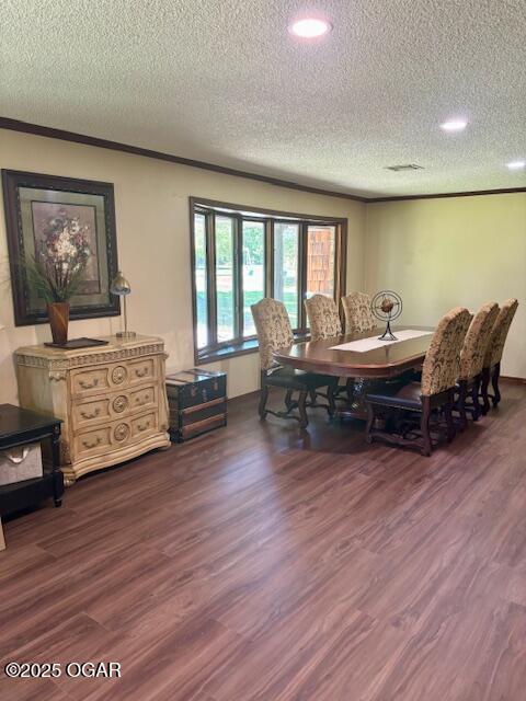 1606 Fairview Ave, Baxter Springs, KS 66713 - dining room featuring a textured ceiling, dark wood-type flooring, recessed lighting, and crown molding