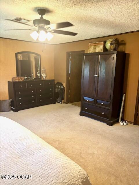 1606 Fairview Ave, Baxter Springs, KS 66713 - carpeted bedroom with a textured ceiling and a ceiling fan