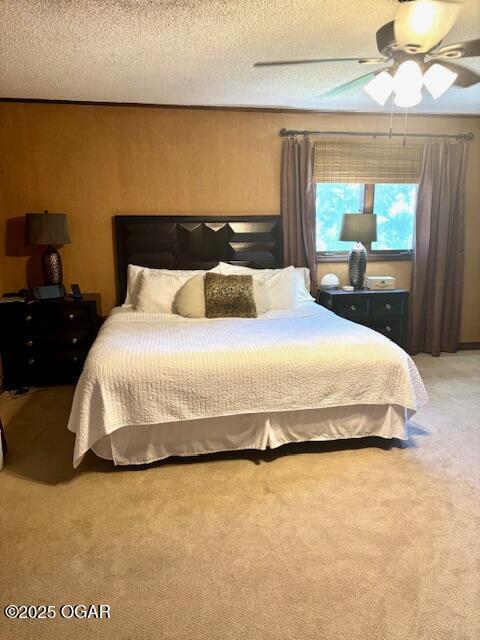 1606 Fairview Ave, Baxter Springs, KS 66713 - bedroom featuring light carpet, a ceiling fan, and a textured ceiling