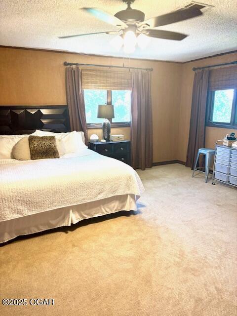 1606 Fairview Ave, Baxter Springs, KS 66713 - bedroom featuring a textured ceiling, light carpet, and a ceiling fan