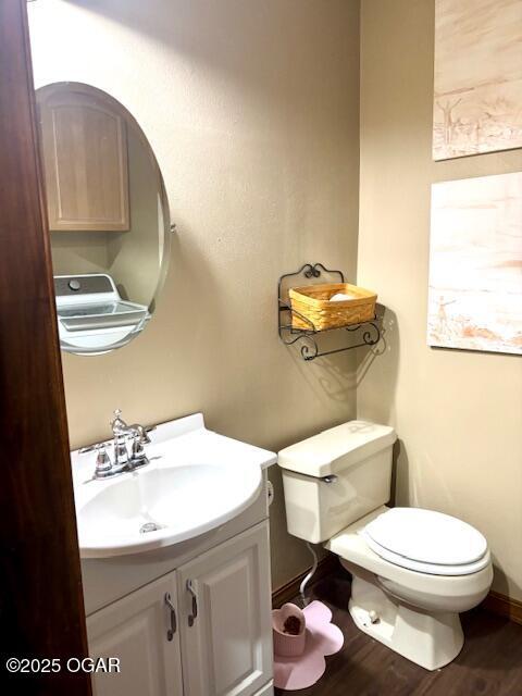 1606 Fairview Ave, Baxter Springs, KS 66713 - half bathroom with vanity and wood finished floors