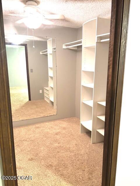 1606 Fairview Ave, Baxter Springs, KS 66713 - spacious closet with ceiling fan and carpet flooring