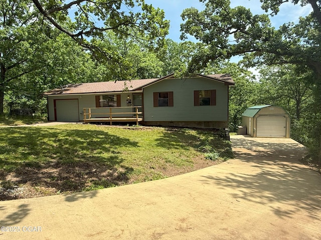 3619 Oak Ridge Dr, Joplin, MO 64804 - view of front facade with concrete driveway, a front lawn, an outbuilding, a detached garage, and an attached garage
