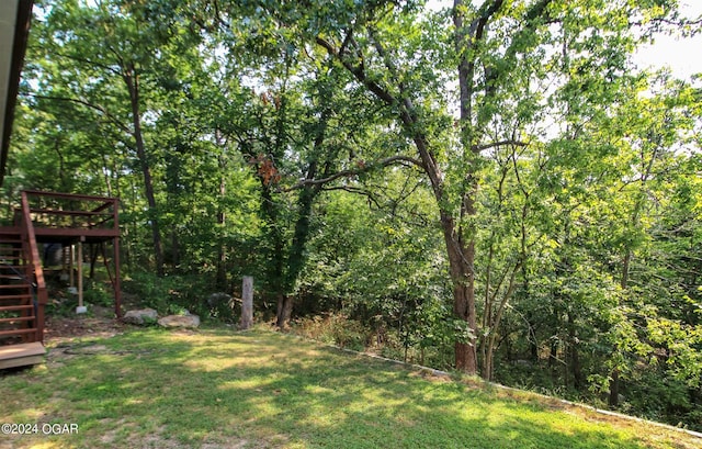 3619 Oak Ridge Dr, Joplin, MO 64804 - view of green lawn featuring stairs, a deck, and a wooded view