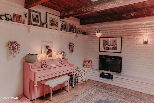 706 S Broadview Dr, Springfield, MO 65809 - living area featuring a wood ceiling with exposed beams, wood finished floors, and a fireplace with raised hearth