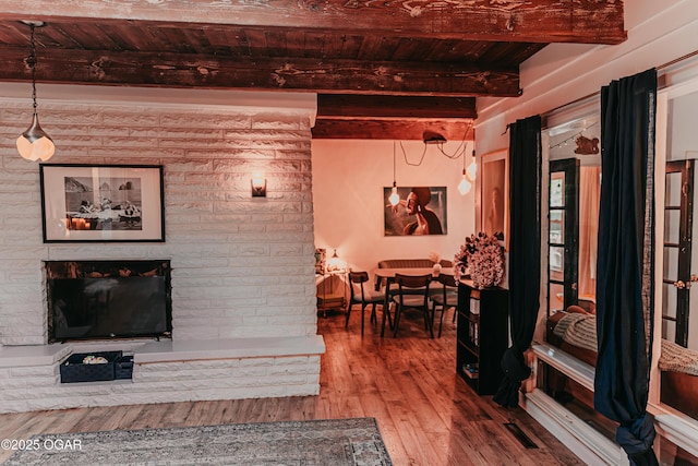 706 S Broadview Dr, Springfield, MO 65809 - living room featuring a wooden ceiling with exposed beams, wood finished floors, and a fireplace