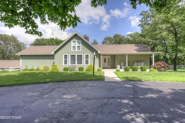 204 Split Rail Dr, Joplin, MO 64801 - ranch-style home featuring a chimney, a front lawn, board and batten siding, and a shingled roof