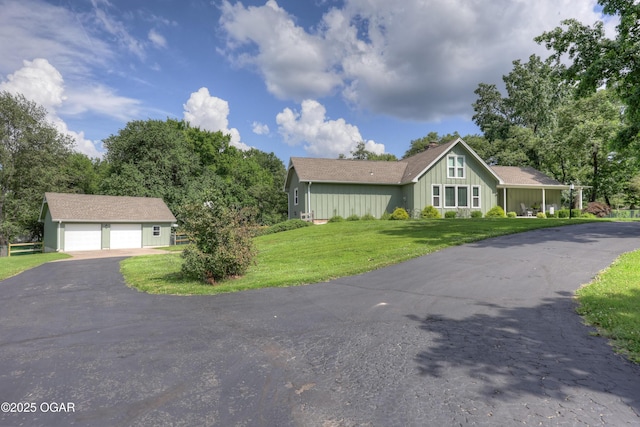 204 Split Rail Dr, Joplin, MO 64801 - view of front of property with board and batten siding, an outdoor structure, a detached garage, and a front lawn
