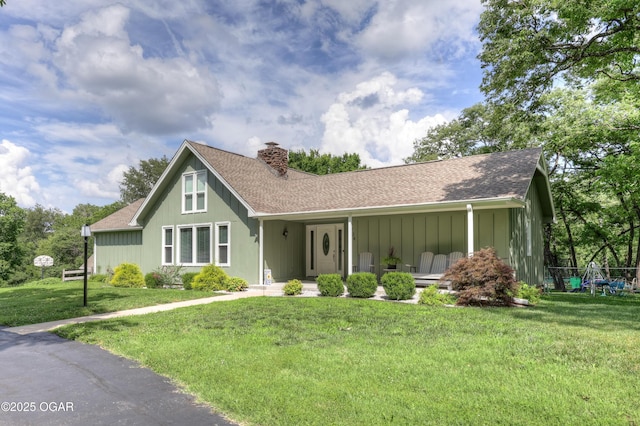 204 Split Rail Dr, Joplin, MO 64801 - view of front of house with a chimney, covered porch, a front lawn, roof with shingles, and board and batten siding