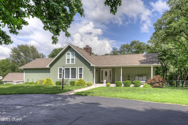 204 Split Rail Dr, Joplin, MO 64801 - view of front of property with a chimney, a front yard, roof with shingles, and board and batten siding