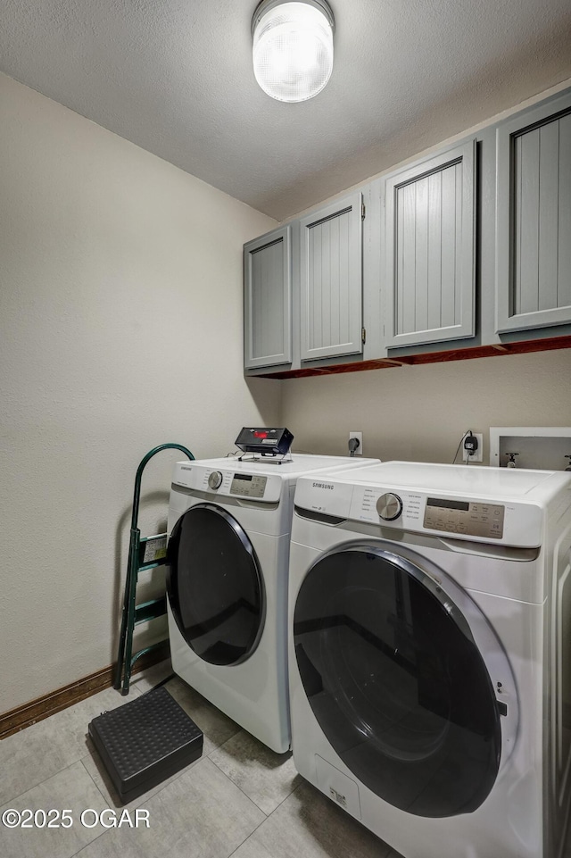 204 Split Rail Dr, Joplin, MO 64801 - washroom featuring cabinet space, washing machine and dryer, light tile patterned flooring, and a textured ceiling