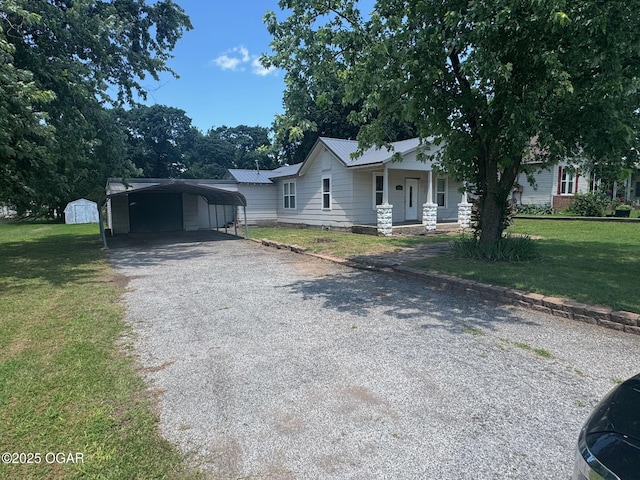 416 E 4th St, Baxter Springs, KS 66713 - view of front of home with a front lawn, driveway, a carport, and a porch