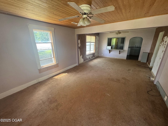 416 E 4th St, Baxter Springs, KS 66713 - carpeted spare room with wood ceiling, healthy amount of natural light, a ceiling fan, and arched walkways