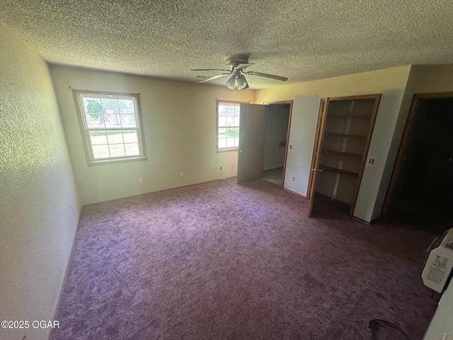 416 E 4th St, Baxter Springs, KS 66713 - unfurnished bedroom featuring a textured ceiling, multiple closets, carpet floors, and ceiling fan