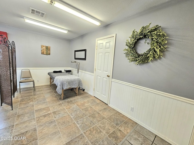 310 W 19th St, Baxter Springs, KS 66713 - bedroom featuring stone finish floors and a wainscoted wall