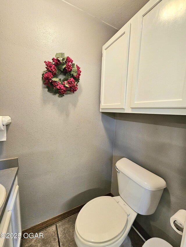 310 W 19th St, Baxter Springs, KS 66713 - half bathroom featuring vanity and tile patterned floors