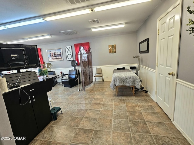 310 W 19th St, Baxter Springs, KS 66713 - bedroom featuring a wainscoted wall and stone finish flooring