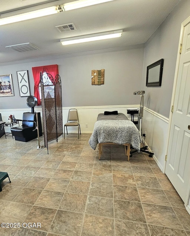 310 W 19th St, Baxter Springs, KS 66713 - bedroom with wainscoting and stone finish flooring