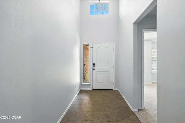 305 Anita Dr, Carl Junction, MO 64834 - entryway featuring plenty of natural light, a towering ceiling, and dark tile patterned floors