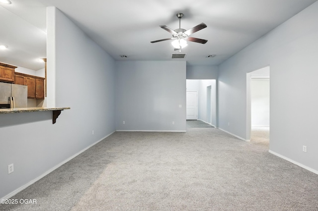 305 Anita Dr, Carl Junction, MO 64834 - unfurnished living room with light carpet and ceiling fan